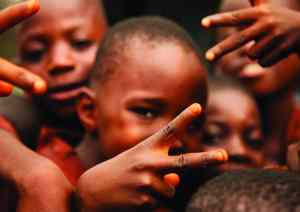 Sierra Leonean children, born after the end of the pernicous civil war, giving the author peace signs. Image courtesy of Genia Boustany
